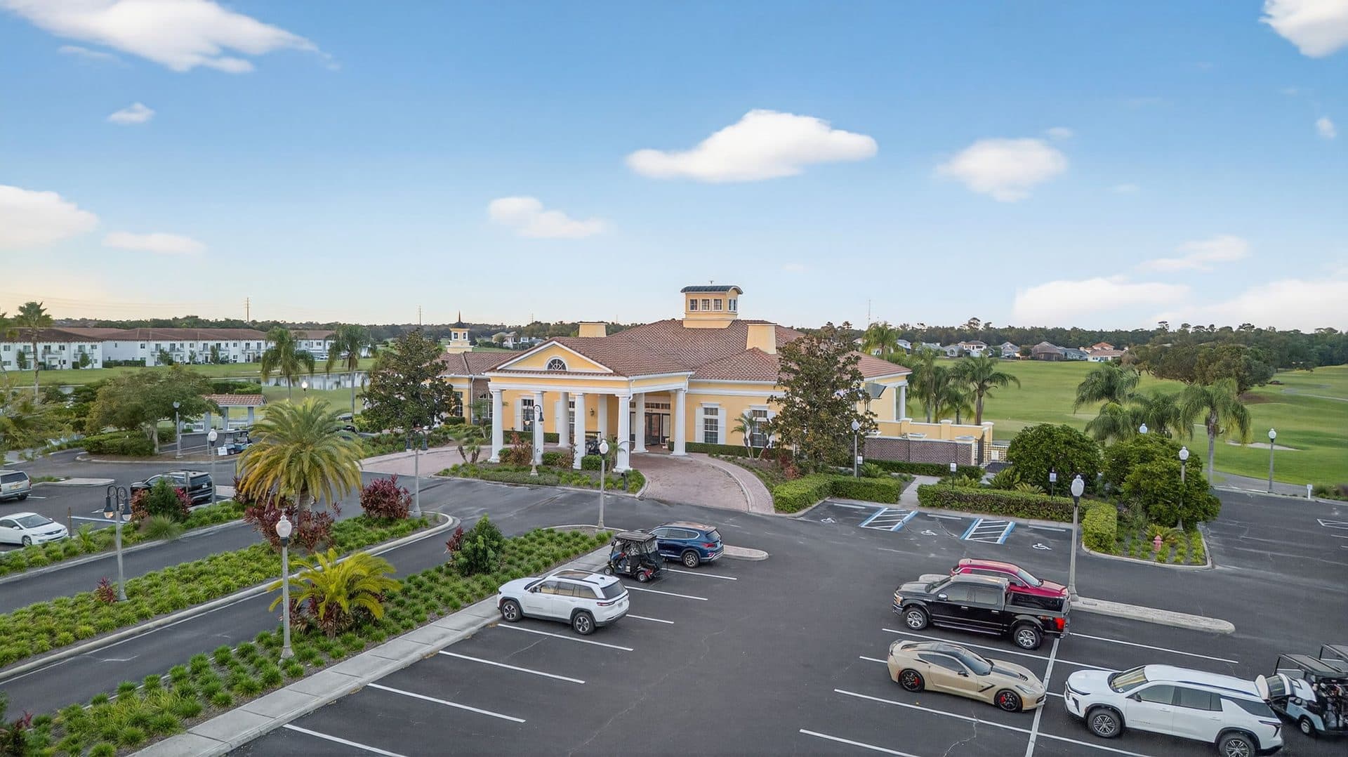 Front of the Providence clubhouse with its parking circle and palms